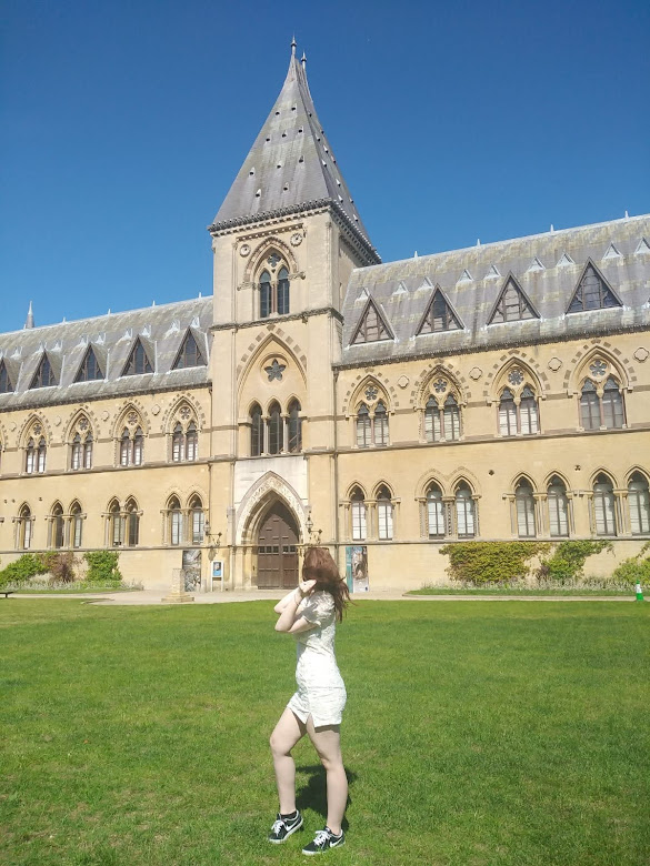 Me stood on the green grass, outside the oxford natural history museum.