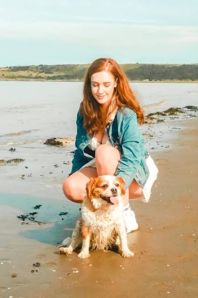 Me and my dog, posing on the sand with the sea behind us on Sand Bay beach.