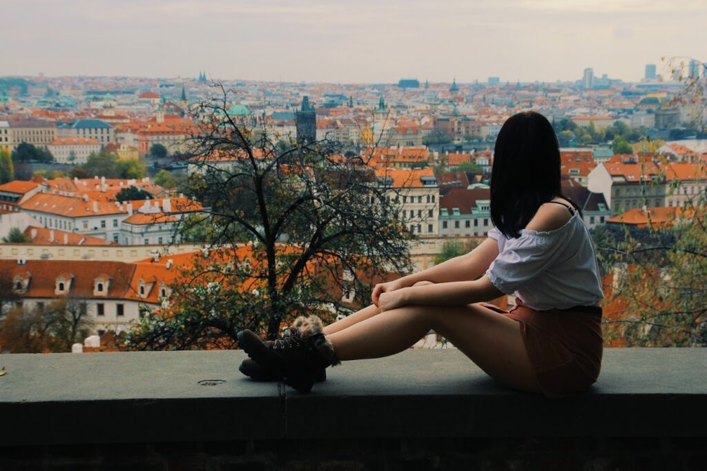 Me sat on a wall at Prague castle, looking out at Prague, czech republic.