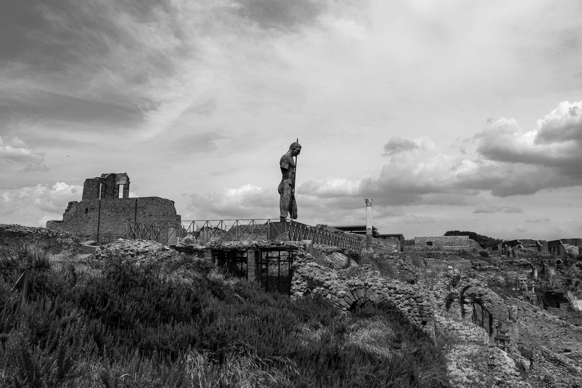 grayscale photo of monumental sculpture on top of ruins
best things to do in Naples