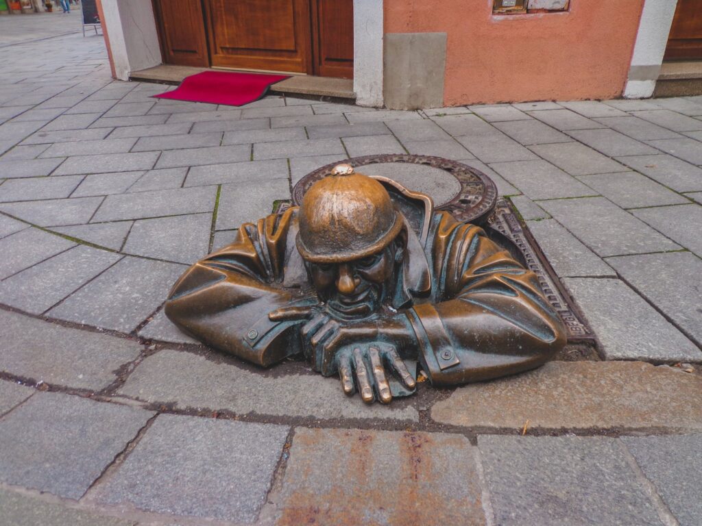 the brass statue of cumil the sewer worker in bratislava slovakia