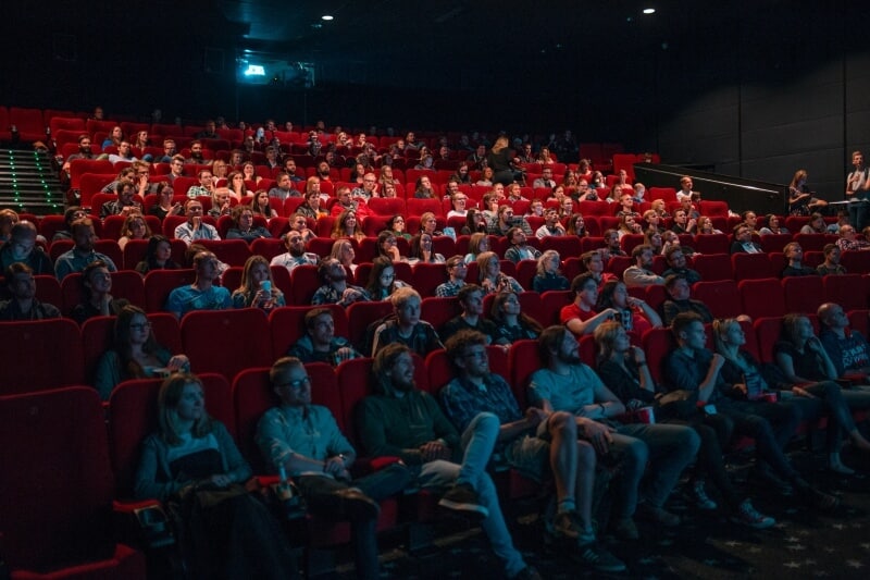 Cinema with people looking at a screen