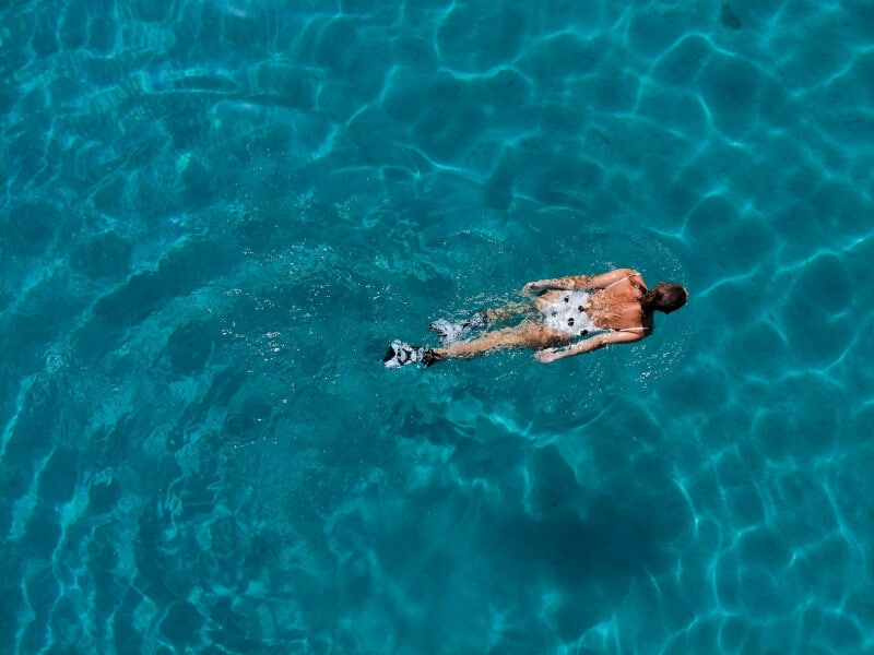 Very blue water with someone swimming