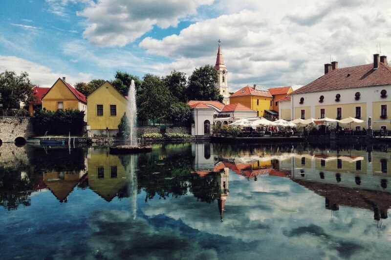 Town in Hungary with a lake reflecting the buildings