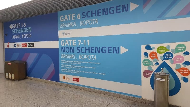 Airport sign pointing to the different gates and zones.